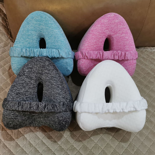 Zero pressure memory foam leg lock pillows in blue, pink, black, and white with ergonomic design and fabric cover